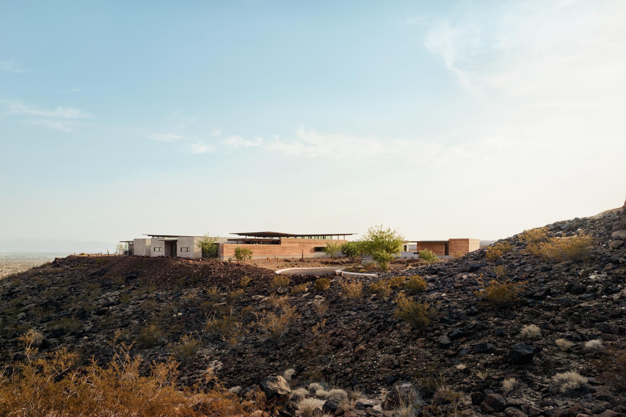 Horizon House uses rammed earth as the primary material which is designed to reflect the surrounding natural topography