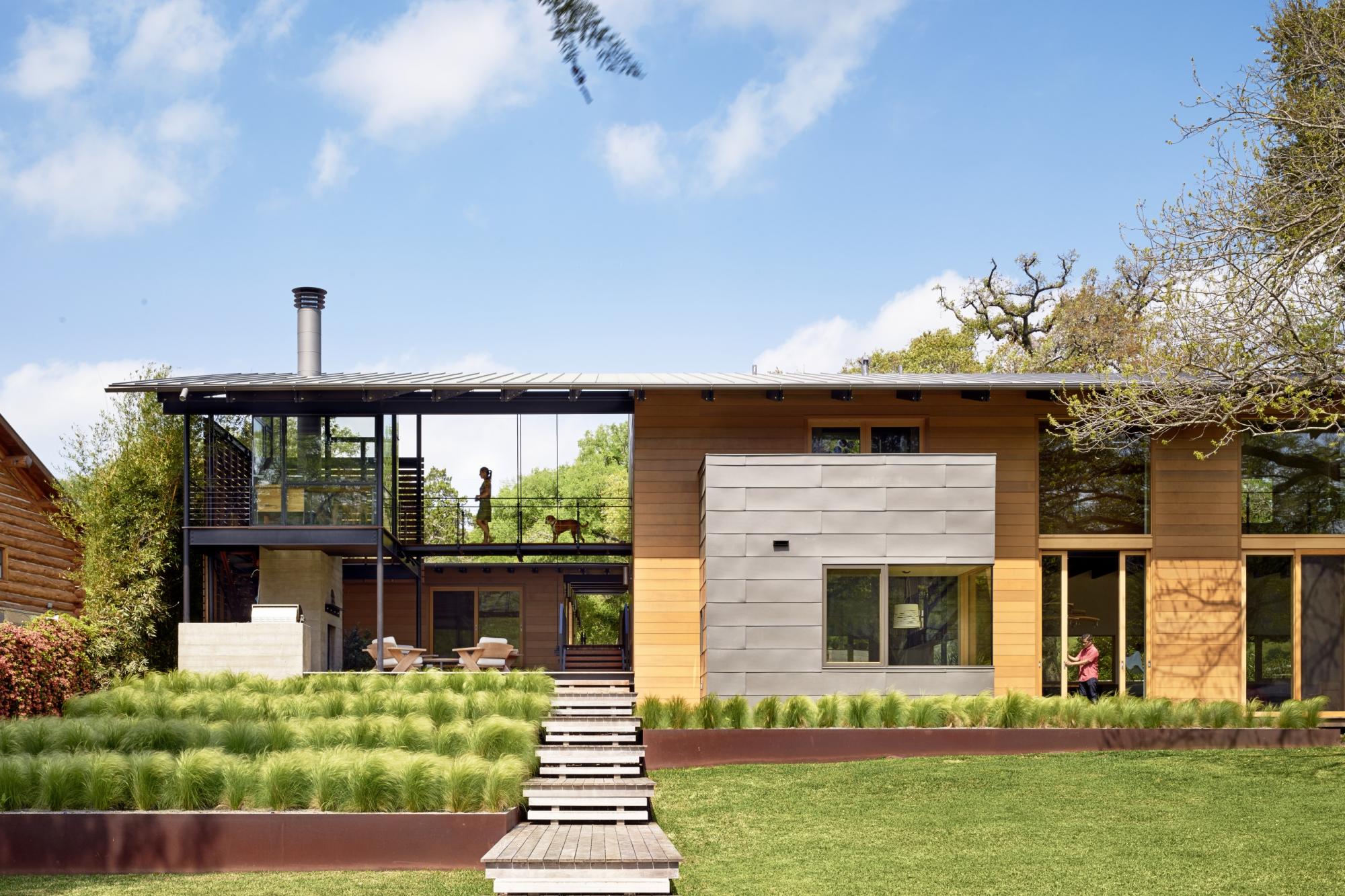 Situated at the confluence of Hog Pen Creek and Lake Austin, Hog Pen Creek Residence was envisioned by its owners as a place that evokes the playfulness of summer on the lake and emphasizes exterior living space. Towering heritage oak trees, a steeply slo