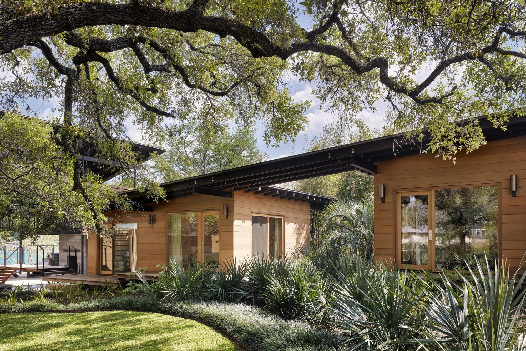 Towering heritage oak trees shade the front lawn and separate  guest quarters