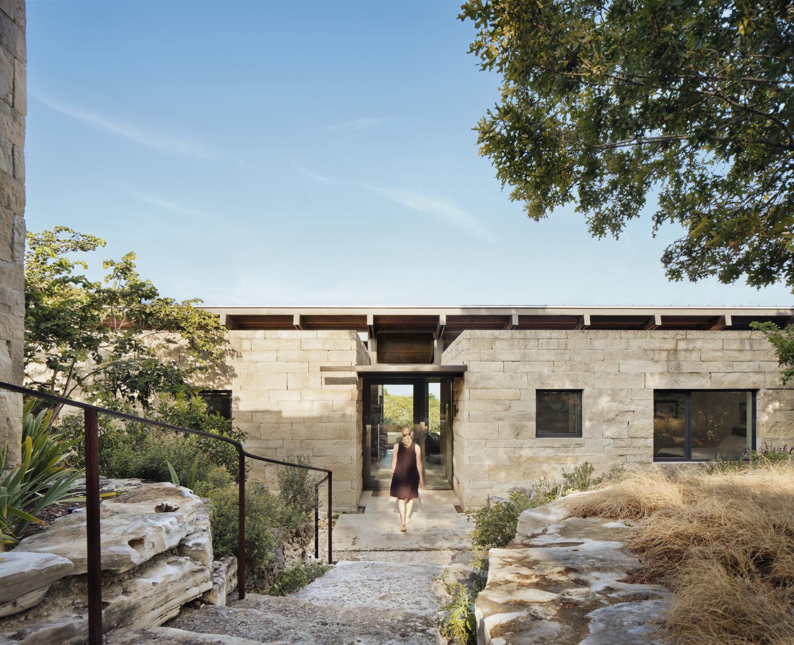 Canyon Preserve entry through rugged rock stairs Canyon Preserve stair step down steep, rocky slopes of oaks and indigenous vegetation, creating a secluded and serene setting for this intimate house