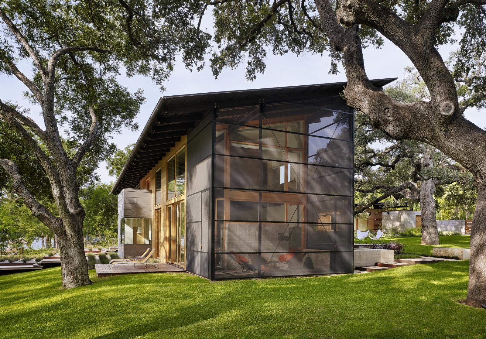 Situated at the confluence of Hog Pen Creek and Lake Austin, Hog Pen Creek Residence was envisioned by its owners as a place that evokes the playfulness of summer on the lake. Twin porches and a two-story living area, with a treetop level master bedroom l